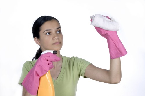 Local technician vacuuming and treating a mattress in Kentishtown