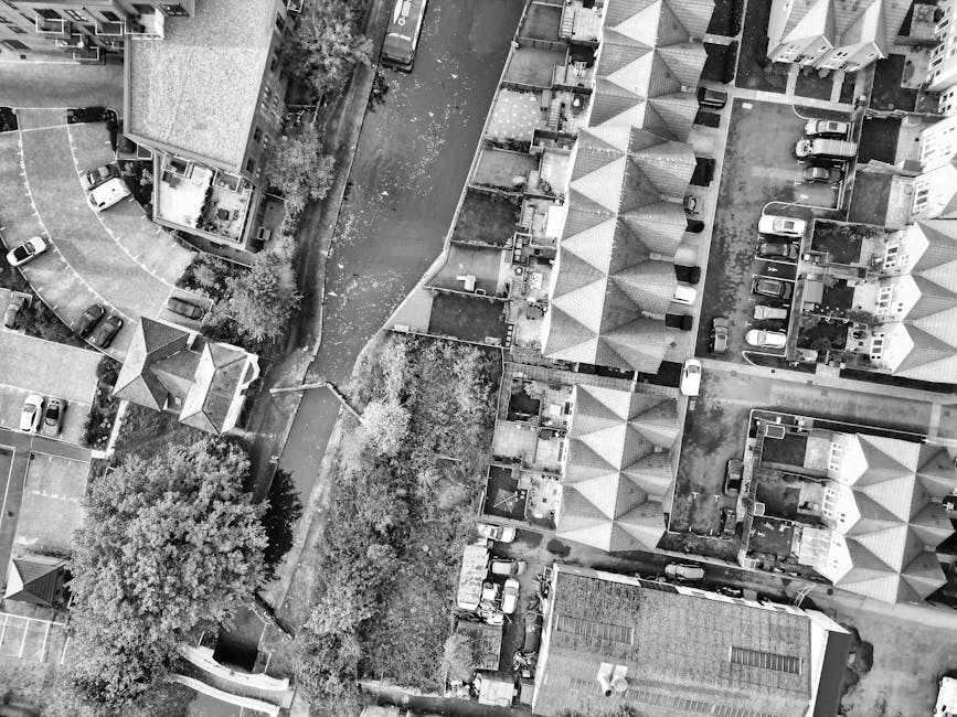 A panoramic view of a densely packed residential neighborhood in Kentish Town, showing a variety of houses with different colors and styles. The houses are situated on a hillside, with some multi-story buildings in the foreground and rows of single-family homes extending into the distance. The rooftops are primarily covered with red or brown tiles, and some buildings feature white or pastel-colored facades. Green trees and foliage are visible among the houses, adding natural contrast to the urban landscape. The sky above is partly cloudy with patches of blue, providing ample natural light that highlights the clean, well-maintained appearance of the community. This image exemplifies a well-kept neighborhood, aligning with the themes of property maintenance and hygiene emphasized by Cleaner Kentish Town in their domestic cleaning services for the area, as seen on the page titled 'Same day house cleaning Kentish Town The Forum, KENTISH TOWN' at cleanerkentishtown.org.uk.